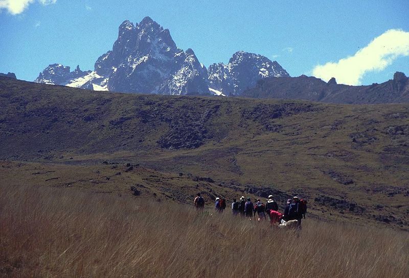 African safari vacations — trekkers walking towards the main peaks.