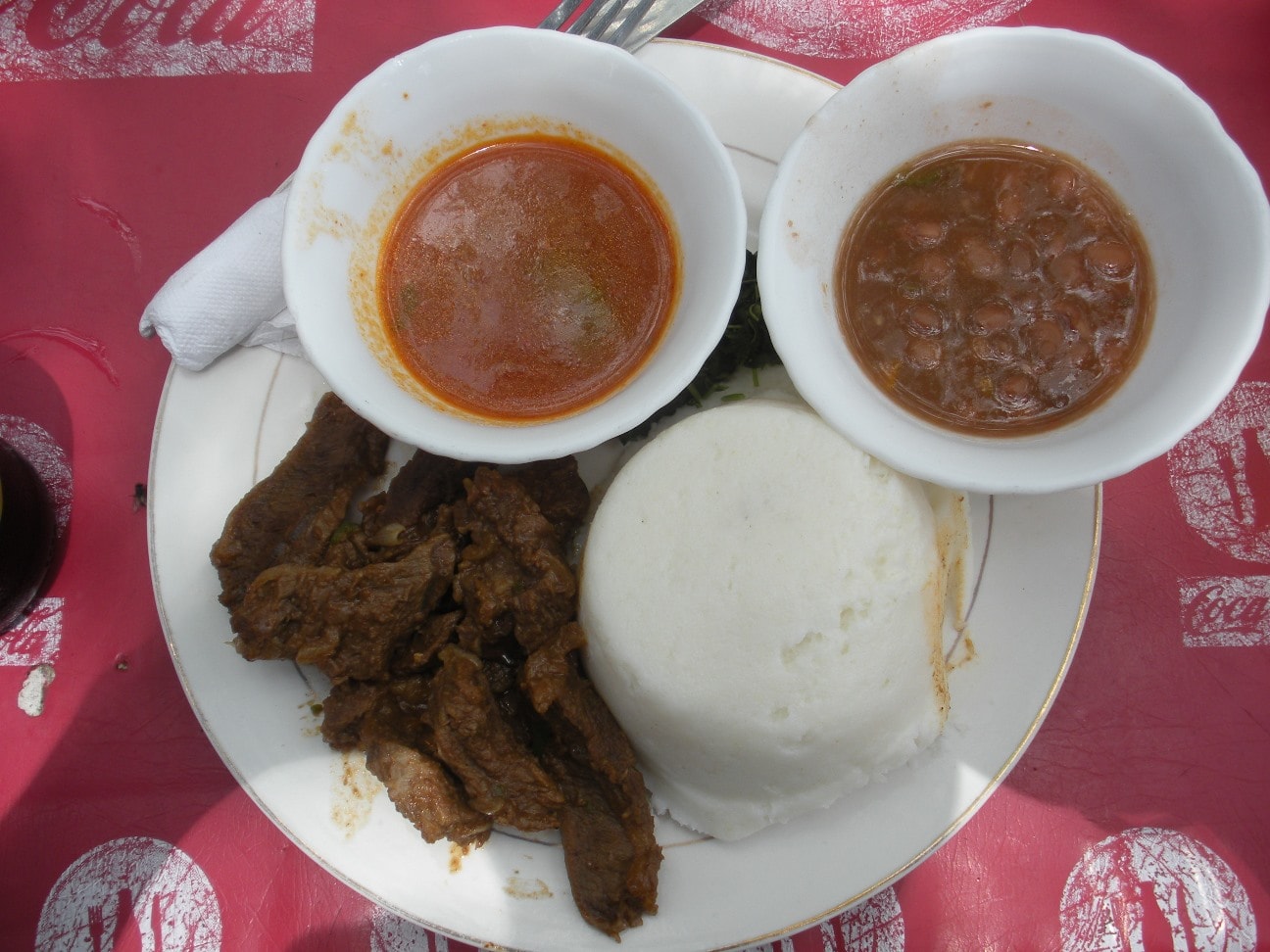 Traditional foods of tanzania — ugali with beef and sauce.