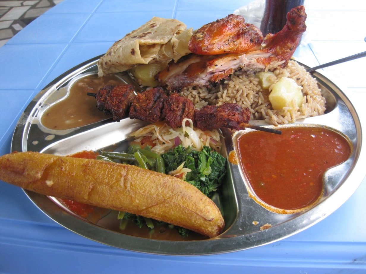 Traditional Foods of Tanzania — Typical Tanzanian Meal Consisting of Pilau Kuku, Mishkaki, Ndizi, Maharage, Mboga, Chapati, and Pili.
