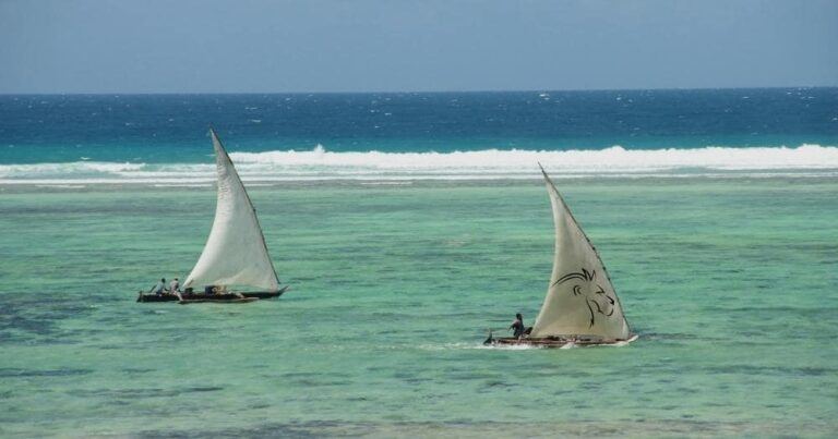 Beach holidays review — portrait of two sailboats on the turquoise water of the zanzibar beach, tanzania.