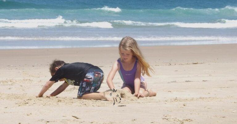 Family Safaris in Africa — Two Kids Playing in the Sand at the Beach.