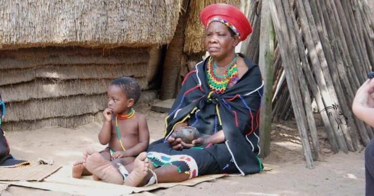 Zulu people of africa — a zulu woman with a child in an african village, south africa.